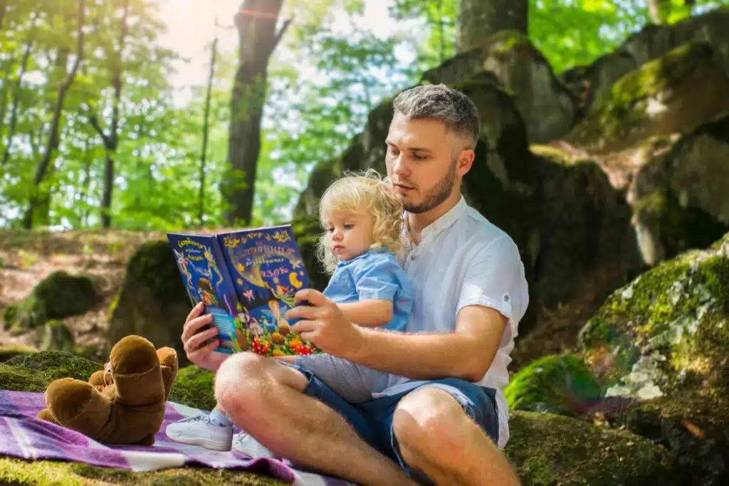 Father reading a book to his daughter